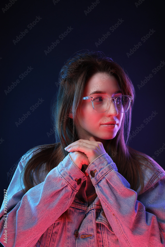 Wall mural Portrait of beautiful young woman in glasses on color background