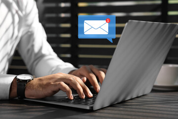 Email. Man using laptop indoors, closeup. Incoming letter notification near device