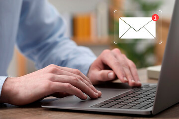 Email. Man using laptop indoors, closeup. Incoming letter notification near device