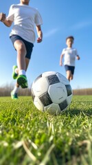 Fototapeta premium Two boys playing soccer on a field