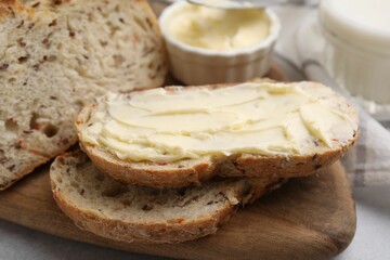 Tasty bread with butter on table, closeup