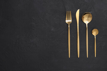 Beautiful cutlery set on black table, flat lay. Space for text