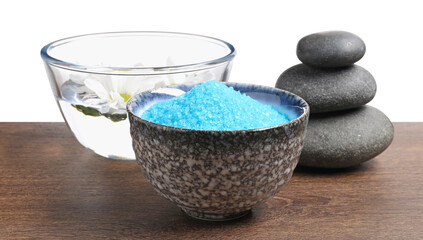 Light blue sea salt in bowl, spa stones and flowers on wooden table against white background