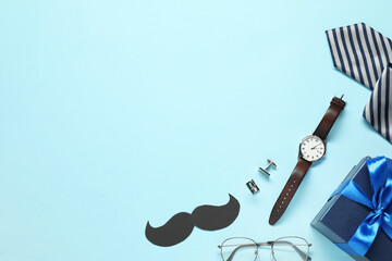 Paper mustache, gift box and men accessories on light blue background, flat lay with space for...