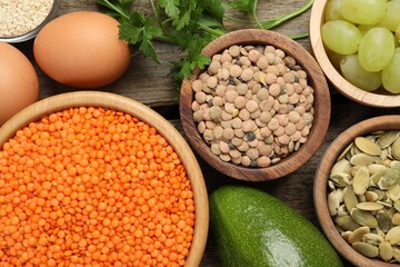 Different products high in natural fats on wooden table, flat lay