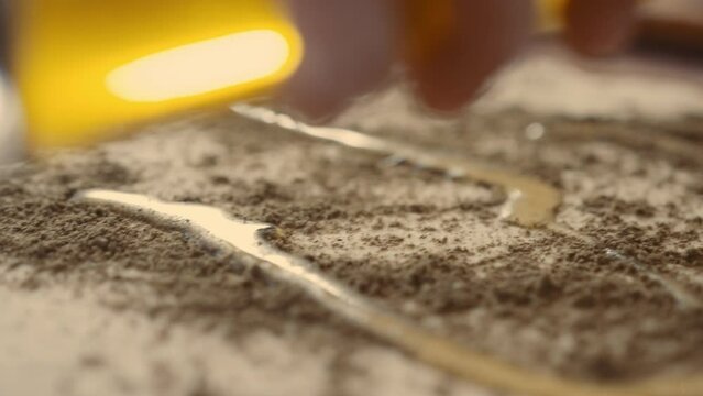 Pouring olive oil over bread dough with zatar spice
