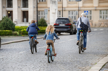 Happy family riding bicycles in the city 