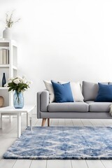 Patterned carpet in front of grey couch with blue pillows in white loft interior with flowers Real photo
