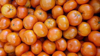 Juicy fresh tangerines close-up on a display case. Tangerine background. Spanish tangerines...