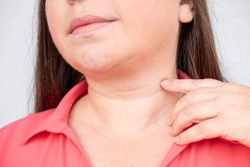 close-up mature woman's neck, highlighting age lines and aging skin, reflecting topics aging,...