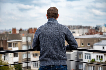 Portrait of a 45 yo man, turning his back on a terrace, Brussels Belgium