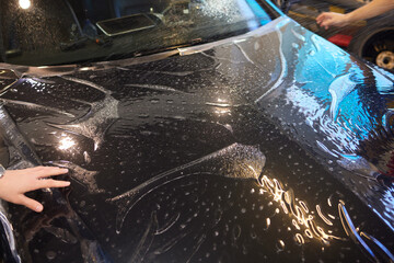 Applying protective film to car hood for added durability