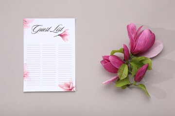 Fototapeta premium Guest list and beautiful flowers on grey background, flat lay. Space for text