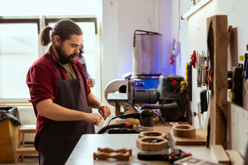 Cabinetmaker in joinery putting on protection glasses before assembling furniture. Woodworking...