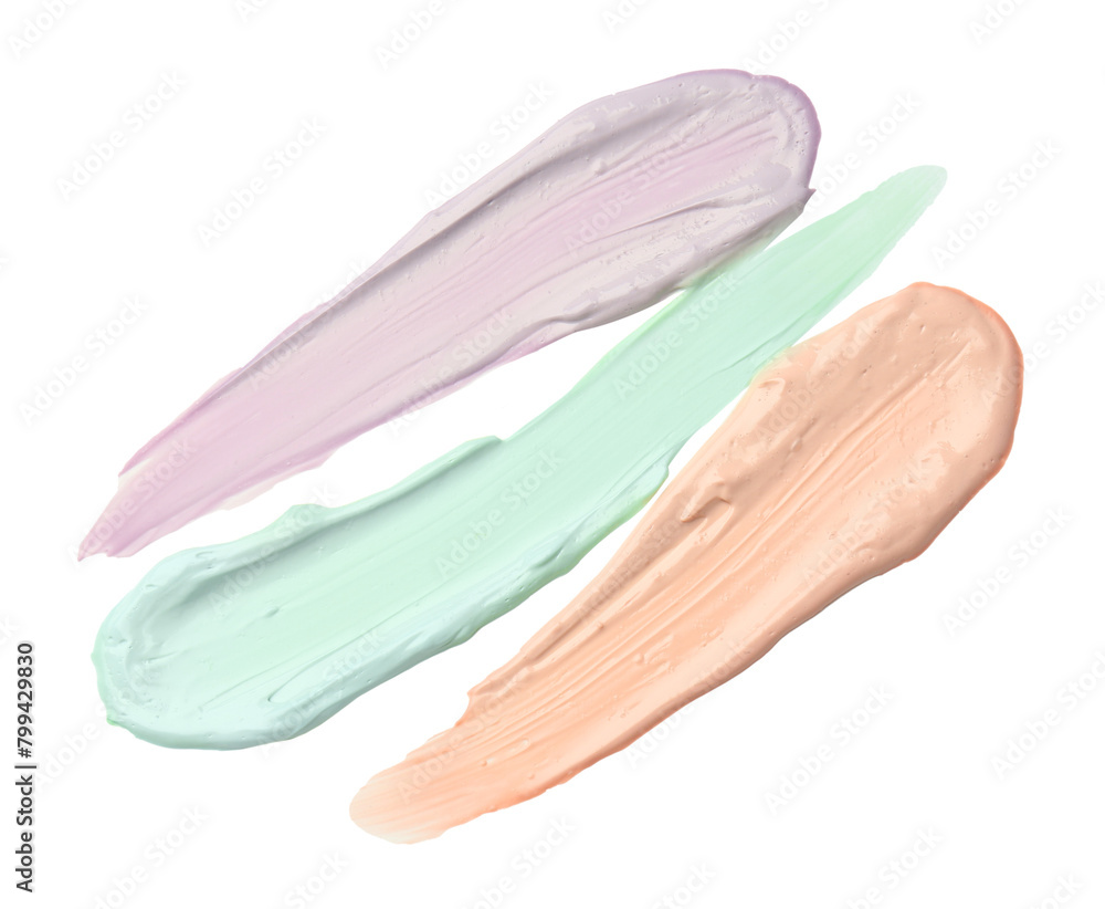 Poster Strokes of pink, green and purple color correcting concealers on white background, top view