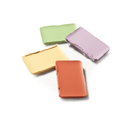 Different color correcting concealers on white background