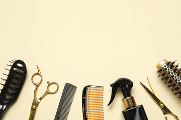 Different hairdresser tools on beige background, flat lay. Space for text