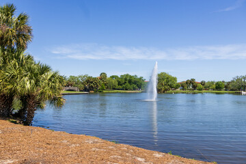 A beautiful spring landscape at New Orleans City Park with people, lush green trees, grass and...