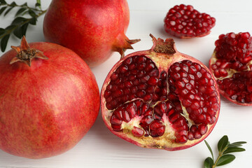 Fresh pomegranates on white wooden table, closeup