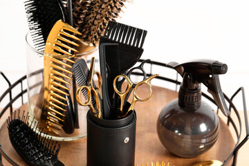Set of hairdresser tools on table in salon, closeup