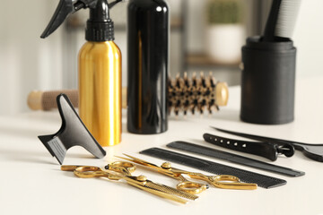 Hairdresser tools. Different scissors and combs on white table in salon
