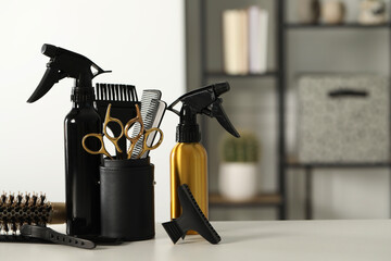 Set of hairdresser tools on table in salon, space for text