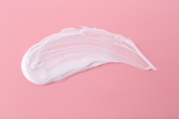 Sample of body care cream on pink background, top view