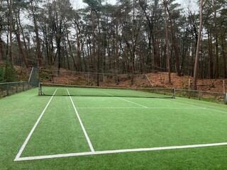 Fototapeta premium Tennis court with artificial grass and net outdoors