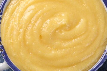 Delicious lemon curd in bowl, top view