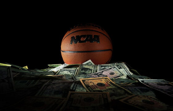 Raleigh, NC - USA - 04-15-2024: An NCAA basketball on a pile of money