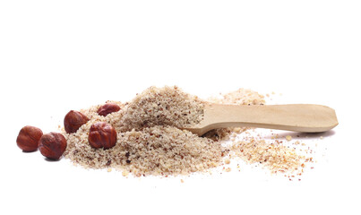 Hazelnuts ground pile in wooden spoon and whole grains isolated on white, side view
