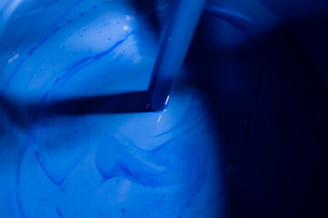 Stirring blue paint