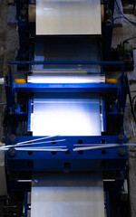 Precision Blade: Machine Cutting Sheet of Paper in Russian Metal Coating Facility