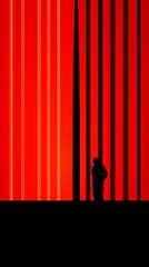 Silhouette of a man against a background of red stripes.
Concept: mystery and loneliness, art and minimalism, mystery.