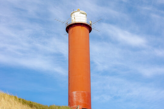 Groote Kaap is a round steel lighthouse painted red with a white light casing, The North Sea coast in the dunes with marram grass, Julianadorp and Groote Keeten, Den Helder, Noord-Holland, Netherlands
