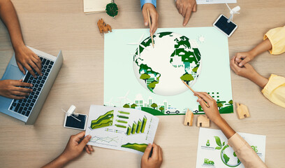 Green city illustration placed on a meeting table during a green business meeting discussion. ESG...