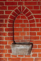 A stone vessel with holy water in the vestibule of a Catholic church. 