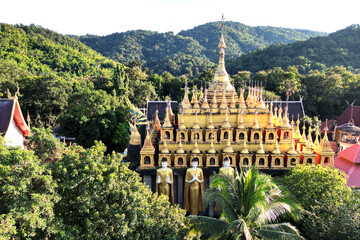 Top view of golden pagoda and church at Wat Phra That Suthon Mongkhon Khiri Samakkhitham. It is a...