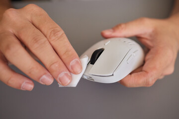 wipes cleaning disinfection of work mouse. Wiping with antibacterial wipe the surface of desk,...