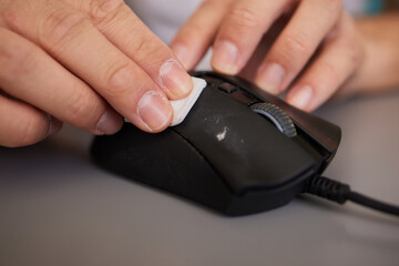 wipes cleaning disinfection of work mouse. Wiping with antibacterial wipe the surface of desk, keyboard
