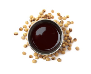 Tasty soy sauce in bowl and soybeans isolated on white, top view