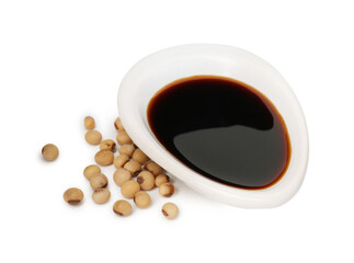 Tasty soy sauce in gravy boat and soybeans isolated on white