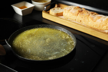 Melted butter in frying pan on cooktop