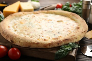 Delicious cheese pizza and ingredients on wooden table, closeup