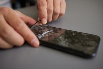 replacing broken glass with a new one. Broken smartphone display. Broken glass phone. Smartphone...
