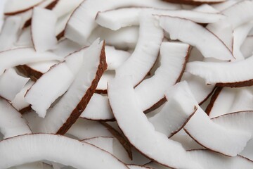 Fresh coconut pieces as background, closeup view