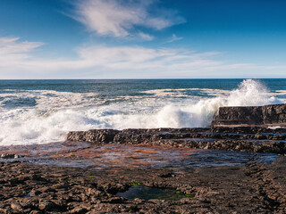 Powerful ocean wave crushes on rough stone coast. Kilkee area, county Clare, Ireland. Nobody. Powerful nature scene. Irish landscape.