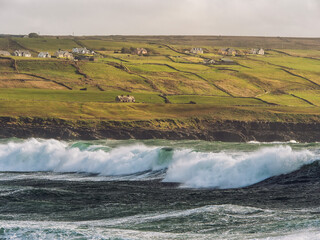 Powerful ocean wave hit rough stone coast in Doolin pier area, county Clare, Ireland. Stunning...