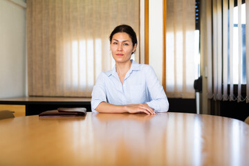 Portrait of focused executive business woman in formal wear posing at office