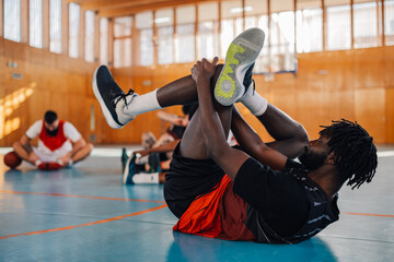 African professional basketball player warming up before training in a hall